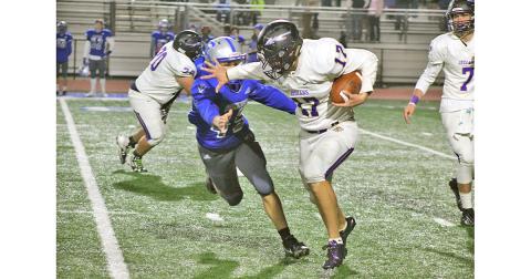 Running back Drew Allison returned from an injury with a vengeance Friday night, stiff arming a Fannin County defender on his way to a first down. (Photo by Jake Cantrell/The Nugget)