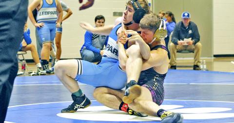 Lumpkin wrestler Levi Seabolt ties up his opponent before flipping him onto his back.
