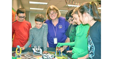 Lumpkin County’s School System Teacher of the Year, Tori Jones, oversees student members of an after-school group doing what Jones believes to be the key to education—hands-on learning. They are members of the Middle School’s FIRST LEGO League Team working (on Halloween) to build robots to accomplish a real-world task. From left are Jon Gooby, Samuel Fuerstenberg, Jones, Cameron Allison, Nathan Berzack and KayLeigh Zahn. The students will compete with other FIRST LEGO League teams Nov. 23—their first year t