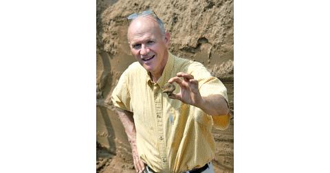 Archaeologist Jim Langford demonstrates a pottery bird effigy from a north Georgia site.