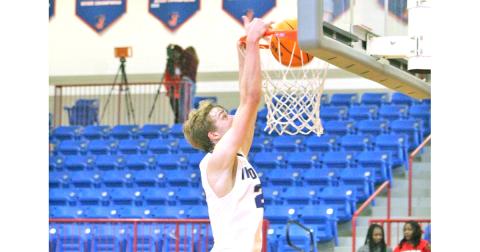 Lumpkin’s Peyton Polk throws down a dunk versus the Hurricanes in the Thanksgiving tournament.