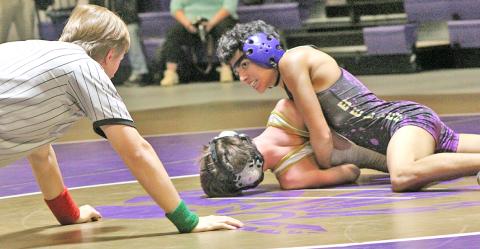 Jeremy Morales squeezes his opponent to try to get his shoulders to the mat during Lumpkin’s home dual versus Rabun Gap on T