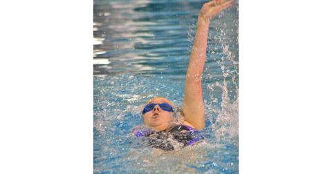Lady Indians swimmer Faith Schofield takes part in the girls 100 yard backstroke event. Schofield had a successful day in the pool when the Lady Indians participated in the RMA Eagle Invite this past Saturday, Dec. 14.