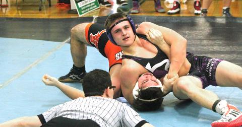 Lumpkin wrestler Ethan Kline squeezes the strength out of his opponent to get his shoulders to the mat for a win by pin during the Murray County Invitational this past weekend.