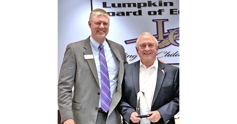 Former Superintendent of Schools David Luke (right) was back at his old stomping ground, the December meeting of the Lumpkin County Board of Education, to accept the Pioneer in Education Award from Justin Old, Director of Pioneer RESA. The award is given to those whose efforts have gone above and beyond to support students and staff.