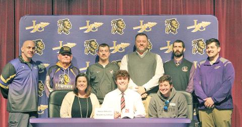 Nolan Wheeler celebrates signing with Newberry College at the LCHS auditorium. Pictured (back row, L to R): LCHS head wrestling coach Sean Hage, LCHS assistant wrestling coach Ed Wright, former LCHS assistant wrestling coach Kris Martin, former LCHS head wrestling coach Brian Matthews, former LCHS assistant coach Sean Mullins and former LCHS assistant wrestling coach Will Mayfield. (Front row): Wheeler’s mother Heather Wheeler, Wheeler and Wheeler’s bonus mom Rhonda Bass.