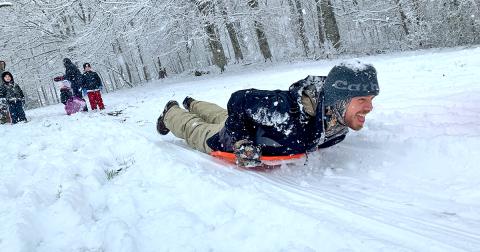 Caleb Sorrells takes full advantage of a surprise Saturday snowfall by taking a speedy sledding run.