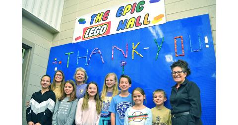 The Epic LEGO Wall received at equally epic dedication at Lumpkin County Elementary School with a ceremony that included, from left, Ally Bicknell, Principal Stacie Gerrells, Charlotte Sessions, School Board Member Lynn Sylvester, Cecilia Woody, Lily Hornbeck, Witt Windham, Avery Caldwell, Maddox Cagle and Media Specialist Kim Jones.