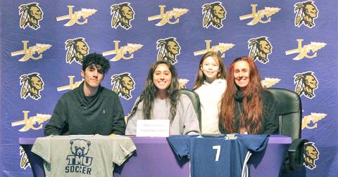 Lady Indians all-time leading goal scorer Hope Kenney (center) celebrates signing with Truett McConnell University at a signing ceremony held at the LCHS auditorium. Pictured (left to right): Kenney’s twin brother Jack Kenney, Kenney’s sister Raini Chandler and Kenney’s mother Rachel Kenney.