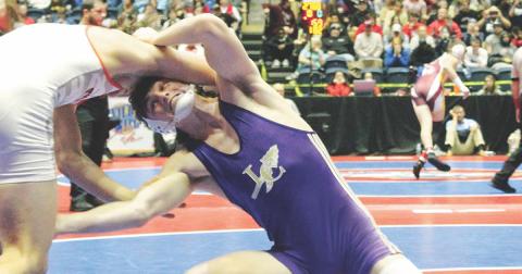 Lumpkin wrestler Sam Irwin takes a shot on his opponent’s leg in the finals match of the GHSA State Wrestling Championship this past season.