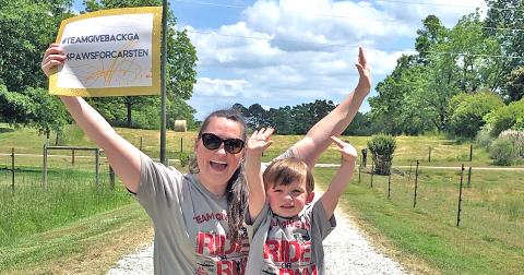 Team Give Back member Mallory Wilkins and her son Bo finish up the virtual fundraiser for Carsten Ussery.