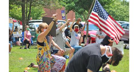 Community members gathered in Hancock Park to show support and unity during an anti-racism protest on Sunday afternoon. 