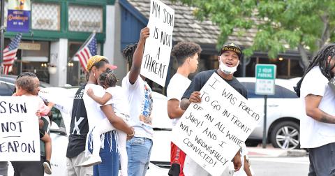 Local resident Antonio Head (far right) leads a rally along with family and friends on the Public Square.