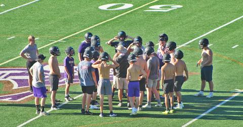 LCHS head football coach Caleb Sorrells huddles up with his players during the first day of mandatory practice on Monday.