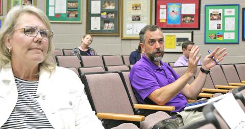 Lumpkin County School Board members Lynn Sylvester and Craig Poore ask questions about the plan to restart school at Monday's meeting.