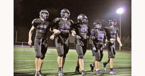 LCHS football seniors (from left) Tanner Kirk, Drew Allison, Joseph Thomas, JoJo Allison and Jared Hoch walk off the field together one final time, following their final game on Friday.