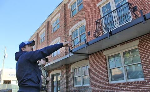 Jose Anaya of Anaya Construction (left) examines details of the new hotel along with Jesus Anaya. Crews are now working on the inside of the building to prepare for the opening planned for December 15.