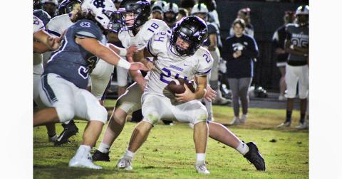 Lumpkin County freshman running back Will Wood fights the Warriors defense for every yard during Friday’s loss to White County.