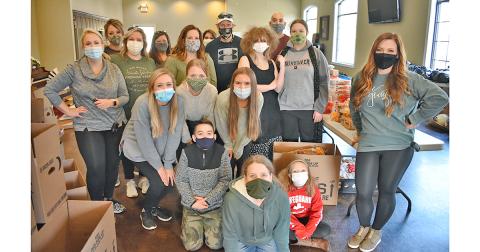 Many volunteers helped distribute Thanksgiving meals to local families in need.