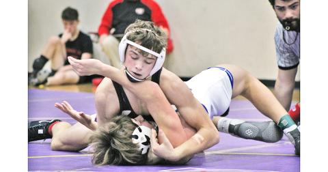 Jack Irwin, the lone returning state placer for Lumpkin, finishes off his opponent with a pin to claim third place in the 145 lb. weight class at the John Smith Invitational Wrestling Tournament held at LCHS on Friday and Saturday.