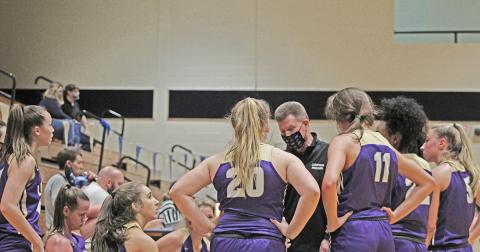 Head basketball coach David Dowse huddles with his team during a timeout in Lumpkin County’s 99-20 win over West Hall.