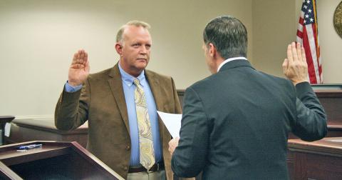 New Lumpkin County Magistrate Court associate judge Jim Sheppard is shown swearing in as the county coroner.