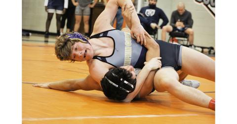 Trevor Coryell finishes off his opponent, securing the pin and six points for his team during the GHSA Dual Wrestling State Preliminaries.