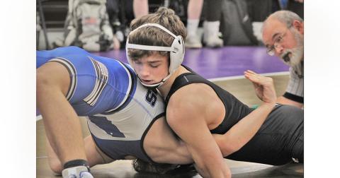 Returning state placer Jack Irwin works to force his opponent flat on his back, resulting in a pin. The junior finished with pins in both matches.