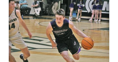 Lumpkin senior captain Gus Faulkner drives to the basket in the Indians’ region tournament game against North Hall.