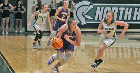MaKenzie Caldwell dribbles down the court on the fast break after getting a steal during Tuesday’s game at North Hall. Caldwell led the team with three of the team’s 10 steals, which helped the team shut down the Trojans’ offense and keep their win streak alive.