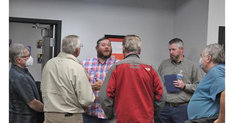 John Dowdy and Adam Scott, far right, talk to other community members about their concerns regarding the alleged controversial lecture given at LCMS in January.