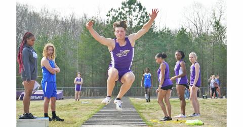 Lumpkin County sophomore Caleb Norrell flies through the air attempting to cover as much distance as possible during the Long Jump event.