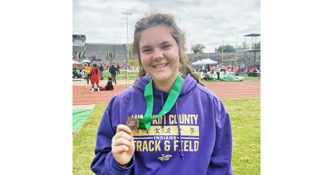 Lumpkin County athlete Grace Jones shows of her medal after placing sixth in the state in Shot Put.