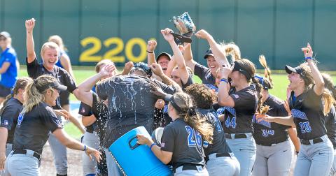 The Nighthawks give head coach Mike Davenport a celebratory dousing after punching their ticket to the NCAA Division II Softball Championship in Denver with back-to-back wins over Lincoln Memorial University on Saturday.