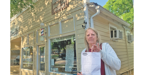 Woody’s Barber Shop owner Cathy Garner paid her garbage bill Tuesday morning, but wasn't happy about the mandatory fee.