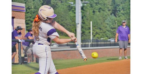 Senior Amma Johnson slams a pitch through the infield for a base hit late in Lumpkin’s 8-2 win over Gilmer County on Friday. With Johnson’s leadoff hit to start the inning, her teammates were able to push her across to start another big inning for the Indians and add some insurance to their lead.
