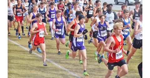 Runners of the Lumpkin County High School Boys Cross Country team try to separate themselves from the pack near the start of the race at the GHSA Cross Country State Championships meet in Carrolton on Friday.