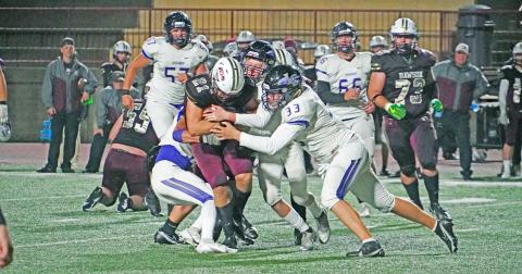 Andrew Adams (right) helps a group of Indians defenders take down the ball carrier to limit the damage in Friday night’s game against Dawson County. The Tigers outpaced en route to a 42-8 win over Lumpkin, giving up three touchdowns to the Tigers running back.