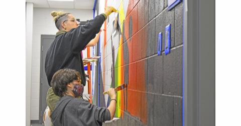 UNG students Cagney Collins and Boston Sundstrom paint the hallway of the new observatory. The observatory is open to the public every clear Friday and Saturday night.