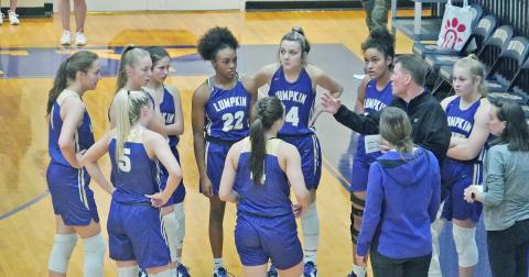 In his first game back since rejoining the team, head coach David Dowse instructs his team with adjustments during a timeout early in Lumpkin’s game against Union County.