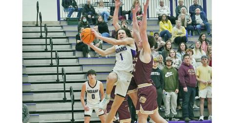 Freshman Cal Faulkner takes on the contact and drives to the basket against two Dawson defenders during Tuesday’s win over the Tigers. Lumpkin notched its first win over their rivals in five years behind a second-half takeover by Faulkner, who scored 15 of his 23 points in the second-half.
