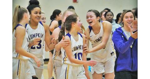 The LCHS Girls Basketball squad celebrates with Breigh Rice (center) following their 72-10 trouncing of West Hall where Rice scored the final points of the game to mark her first career varsity basket.