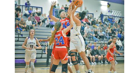 Junior center Kate Jackson goes up strong, taking on contact from two defenders mid-shot. Jackson averaged 9.3 points and 3.6 steals per game during the LCHS hosted Kelly King Holiday Classic on Dec. 28-30 where the Indians swept the competition en route to earning the championship trophy.