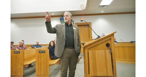 Lumpkin County Planning Director Bruce Georgia points to posters spread throughout the boardroom showing different aspects of the developing land use plans with sections for citizens to write their comments alongside for consideration.