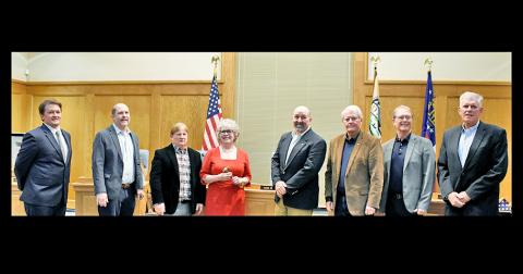 Former and new city council members gathered together at the January 4 meeting, where three new members: Ryan Reagin, far left, Ross Shirley, far right, and Mayor JoAnne Taylor, center, were sworn in.  Also pictured are, from left, council members Roman Gaddis, Johnny Ariemma, former mayor Sam Norton, council members Ron Larson and Joel Cordle.