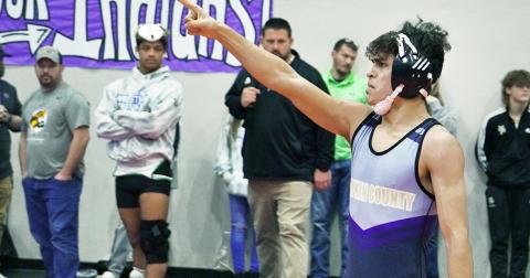After a last-second pin saved his match and put him through to the finals at Sectionals, Lumpkin wrestler Kerwin Martinez points to the crowd in celebration. Martinez often shows emotion after winning important matches, citing that he wrestles to honor those close to him.