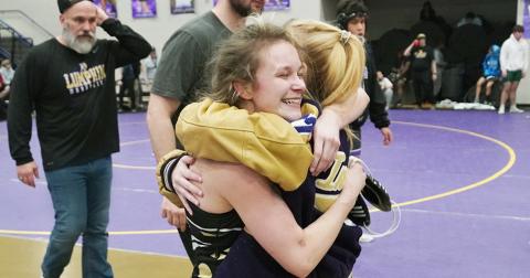 Lumpkin wrestler Chloe Carver meets her sister Kylie with a big hug after clinching a berth at the State tournament. Carver, a senior, is making her long-awaited first appearance at the State tournament after injury held her out last year.