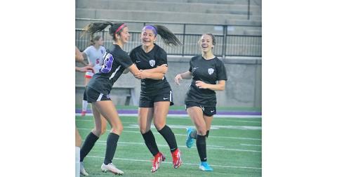 After scoring what turned out to be the game-winning goal in overtime, Andrea Limehouse (left) celebrates with her teammates (from left) Nicole Limehouse and Bri James.