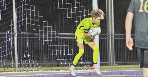 LCHS keeper Braunner Boegner makes a save to prevent a goal during the team’s match against East Forsyth on Tuesday. Boegner blocked shot after shot in the match to keep the game going for the Indians.