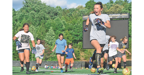 Campers scramble through the gauntlet as a high-intensity version of soccer-dodge-ball tests their agility at the community soccer camp at Lumpkin County High School last week.